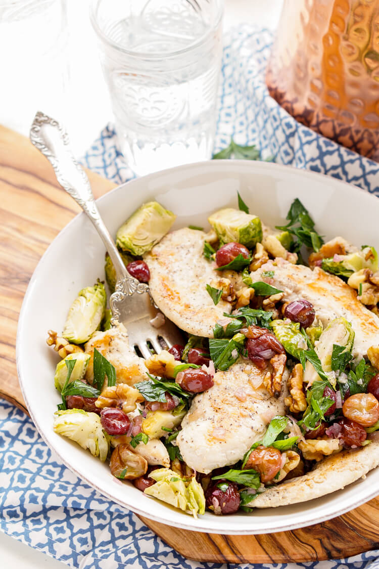 This Chicken Dinner is loaded with seasonal flavors and comes together in just 30 minutes! Roasted Brussels sprouts and red grapes mixed with shallots and garlic and the crunch of walnuts bring this whole meal to life!