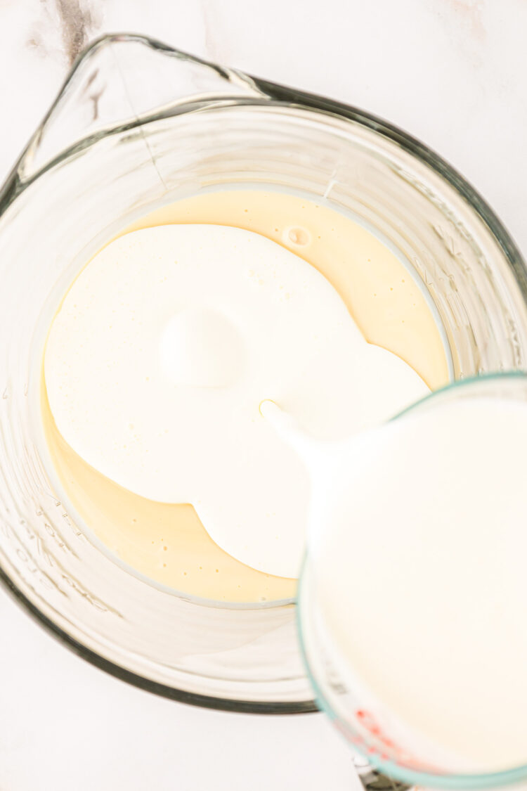 Heavy cream being poured into a bowl with sweetened condensed milk.