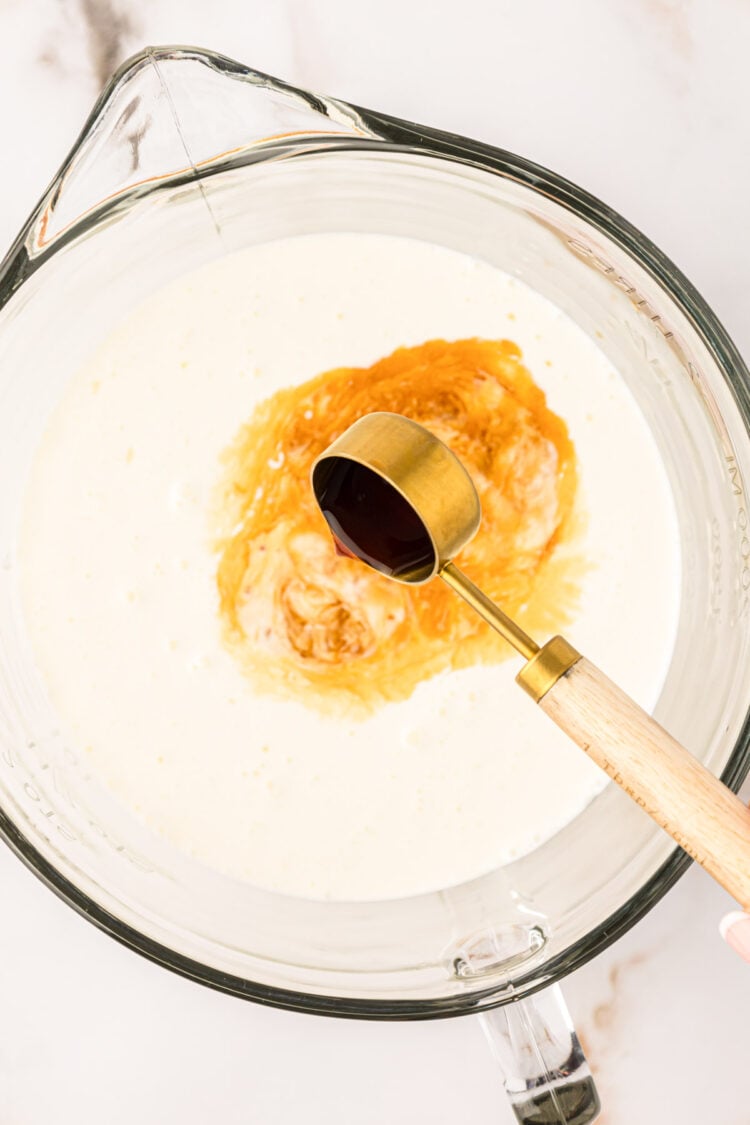 Vanilla being added to a bowl of homemade coffee creamer.