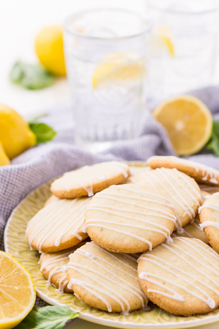 These Lemon Basil Shortbread Cookies will melt in your mouth, they're rich, sweet, and flaky. Made with butter, confectioners' sugar, flour, lemon zest, basil, and salt, they're perfect for tea, parties, or snacking!