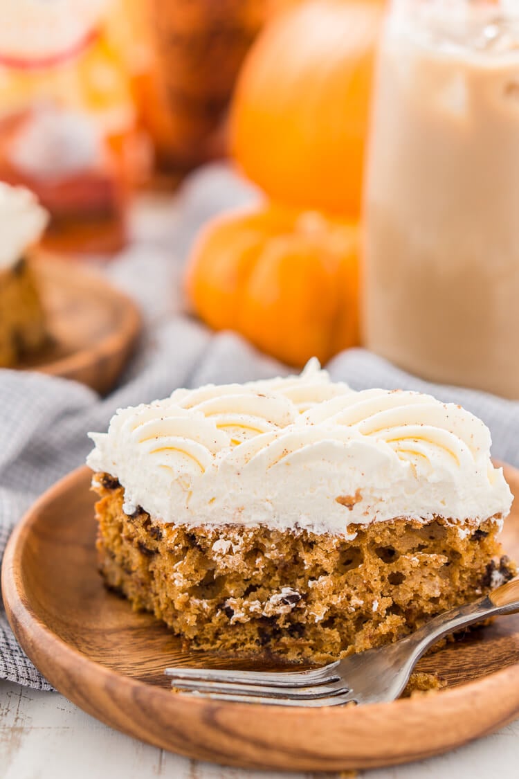 This Pumpkin Chocolate Chip Poke Cake is a deliciously seasonal dessert that's great for potlucks and family gatherings. A dense pumpkin spice cake soaked in sweetened condensed milk and loaded with chocolate chips is topped with a fluffy cheesecake frosting and dusted with cinnamon!