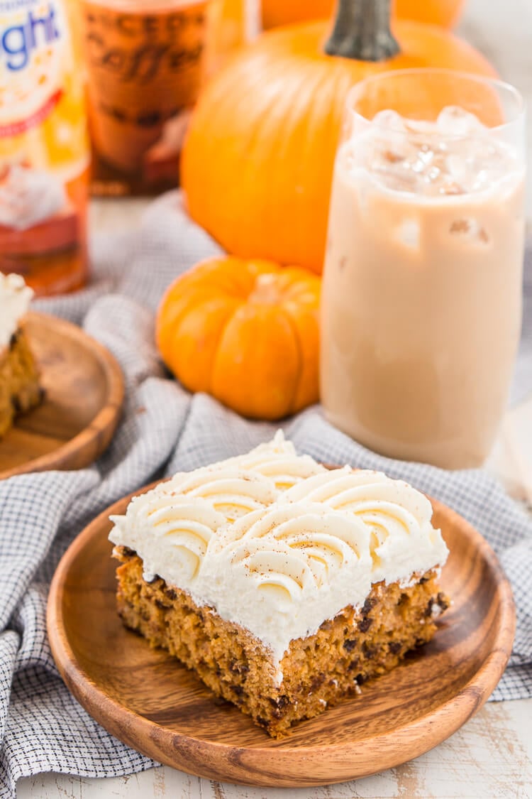 This Pumpkin Chocolate Chip Poke Cake is a deliciously seasonal dessert that's great for potlucks and family gatherings. A dense pumpkin spice cake soaked in sweetened condensed milk and loaded with chocolate chips is topped with a fluffy cheesecake frosting and dusted with cinnamon!