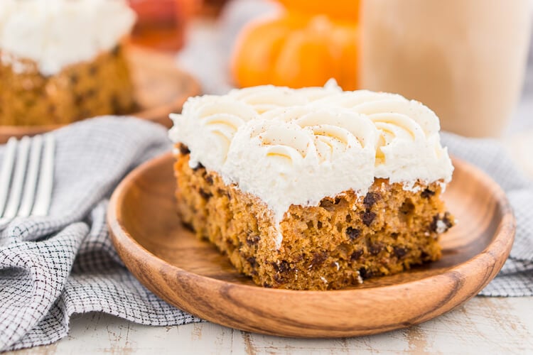 This Pumpkin Chocolate Chip Poke Cake is a deliciously seasonal dessert that's great for potlucks and family gatherings. A dense pumpkin spice cake soaked in sweetened condensed milk and loaded with chocolate chips is topped with a fluffy cheesecake frosting and dusted with cinnamon!