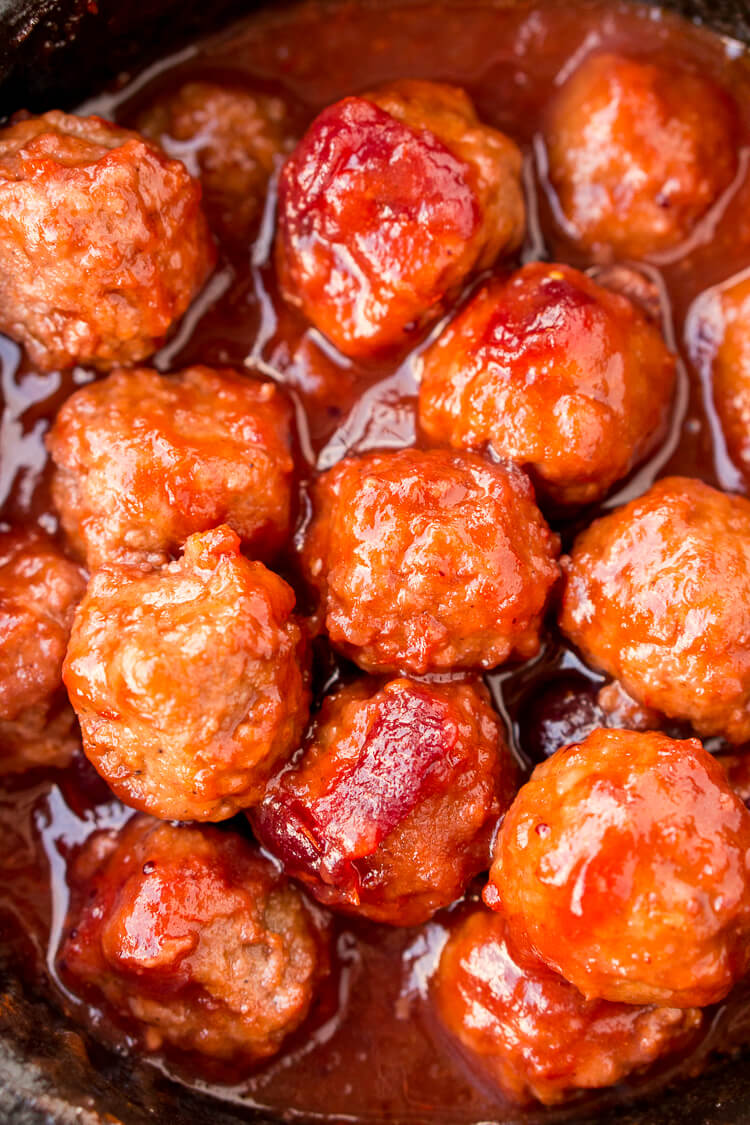 These Cranberry Orange Meatballs are made with just 4 ingredients with just 5 minutes of prep work! Let your crockpot take care of the rest and serve up this delicious appetizer at your holiday and game day parties!