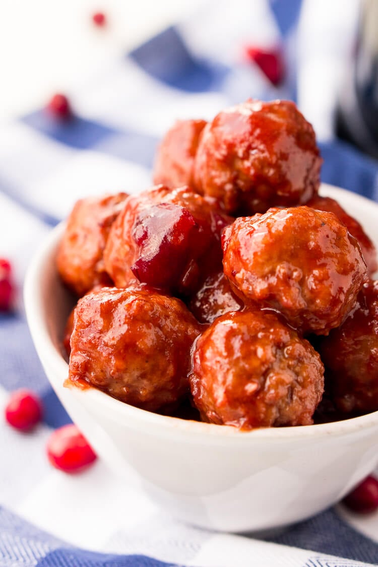 These Cranberry Orange Meatballs are made with just 4 ingredients with just 5 minutes of prep work! Let your crockpot take care of the rest and serve up this delicious appetizer at your holiday and game day parties!