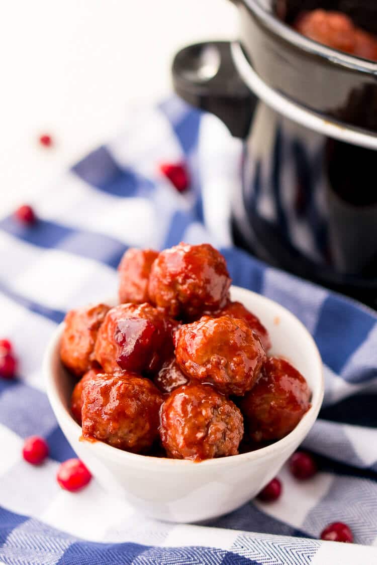 These Cranberry Orange Meatballs are made with just 4 ingredients with just 5 minutes of prep work! Let your crockpot take care of the rest and serve up this delicious appetizer at your holiday and game day parties!