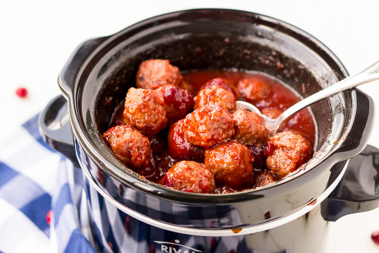 These Cranberry Orange Meatballs are made with just 4 ingredients with just 5 minutes of prep work! Let your crockpot take care of the rest and serve up this delicious appetizer at your holiday and game day parties!