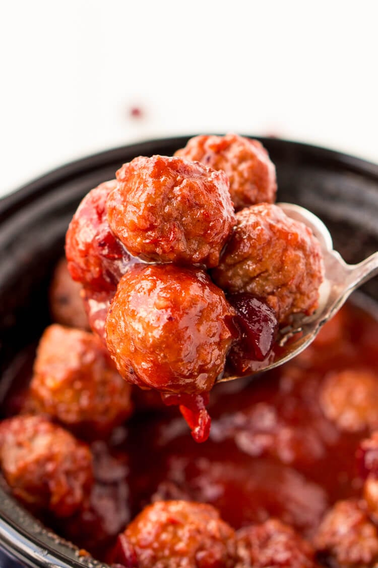 These Cranberry Orange Meatballs are made with just 4 ingredients with just 5 minutes of prep work! Let your crockpot take care of the rest and serve up this delicious appetizer at your holiday and game day parties!