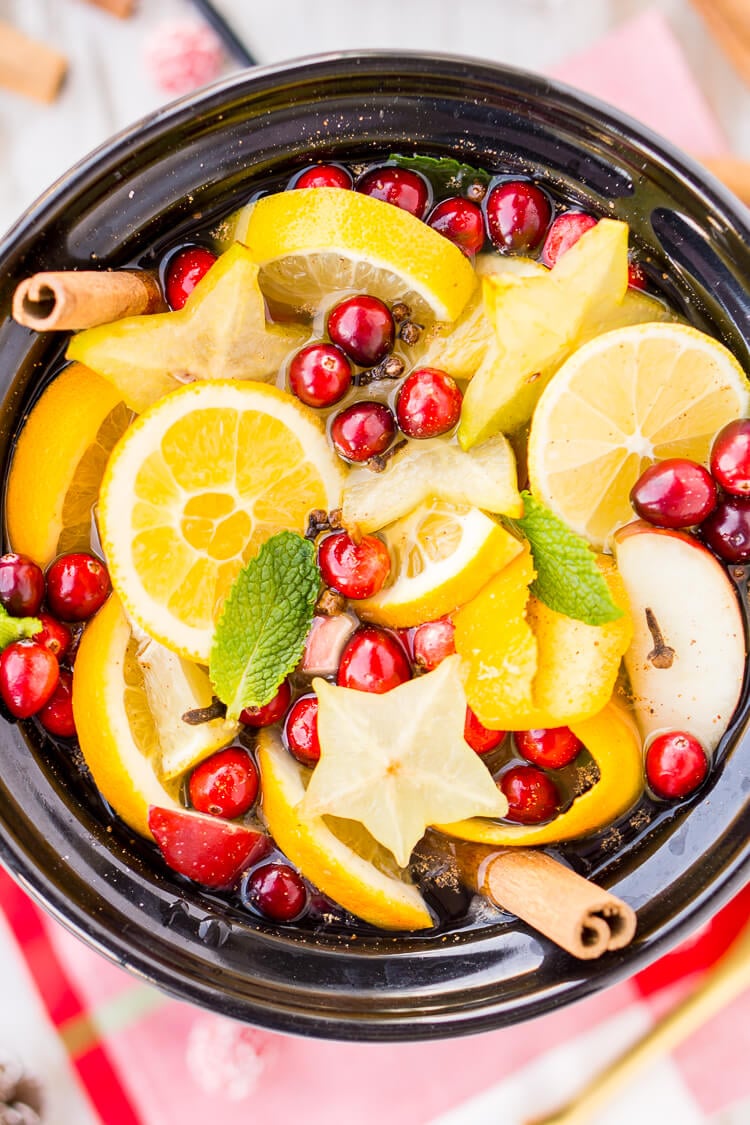 This DIY Holiday Crock Pot Potpourri will have your house smelling amazing all season long with sweet and spicy aromas of cranberries, oranges, mint, cloves, cinnamon, and more!