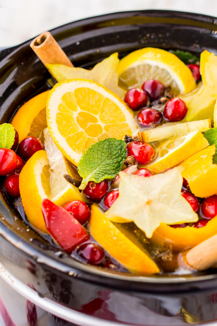 This DIY Holiday Crock Pot Potpourri will have your house smelling amazing all season long with sweet and spicy aromas of cranberries, oranges, mint, cloves, cinnamon, and more!