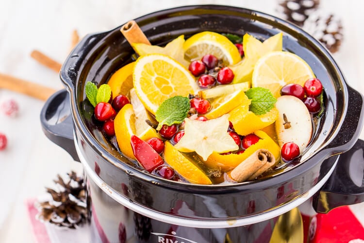 This DIY Holiday Crock Pot Potpourri will have your house smelling amazing all season long with sweet and spicy aromas of cranberries, oranges, mint, cloves, cinnamon, and more!