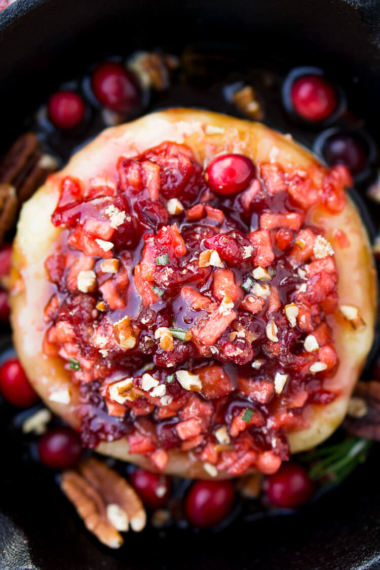 Apple Cranberry Baked Brie is a delicious cheese appetizer loaded with brown sugar, maple syrup, pecans, and an apple cranberry compote.