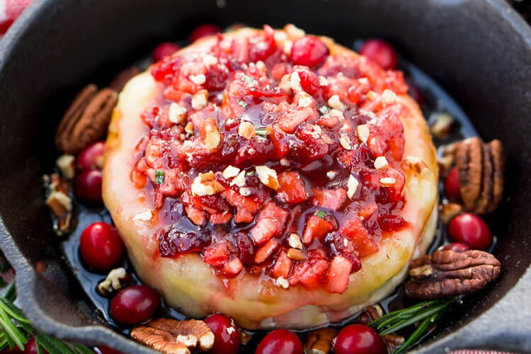 Apple Cranberry Baked Brie is a delicious cheese appetizer loaded with brown sugar, maple syrup, pecans, and an apple cranberry compote.