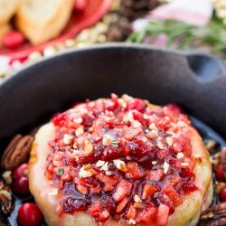 Apple Cranberry Baked Brie is a delicious cheese appetizer loaded with brown sugar, maple syrup, pecans, and an apple cranberry compote.