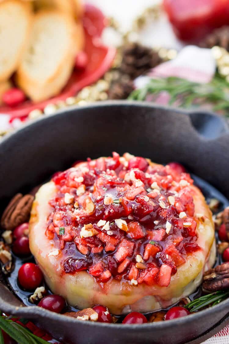 Apple Cranberry Baked Brie is a delicious cheese appetizer loaded with brown sugar, maple syrup, pecans, and an apple cranberry compote.