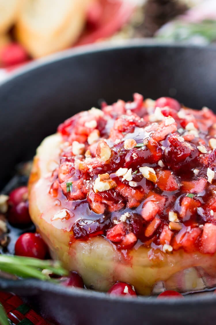 Apple Cranberry Baked Brie is a delicious cheese appetizer loaded with brown sugar, maple syrup, pecans, and an apple cranberry compote.