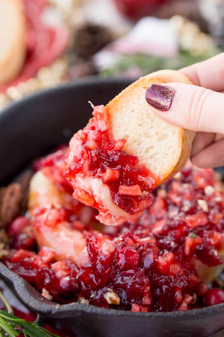 Apple Cranberry Baked Brie is a delicious cheese appetizer loaded with brown sugar, maple syrup, pecans, and an apple cranberry compote.