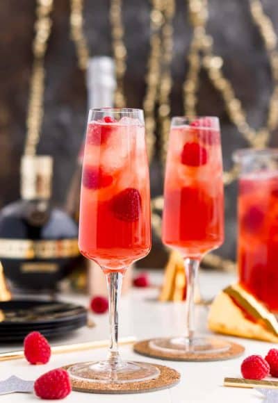 New Year's Eve Champagne Punch is loaded with Triple Sec, blackberry brandy, Chambord, pineapple juice, ginger ale, and champagne for a drink that's sure to impress all your NYE party guests!