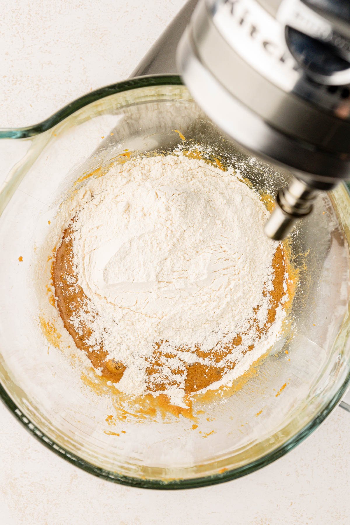 Dry ingredients being added to batter to make stick toffee pudding. 