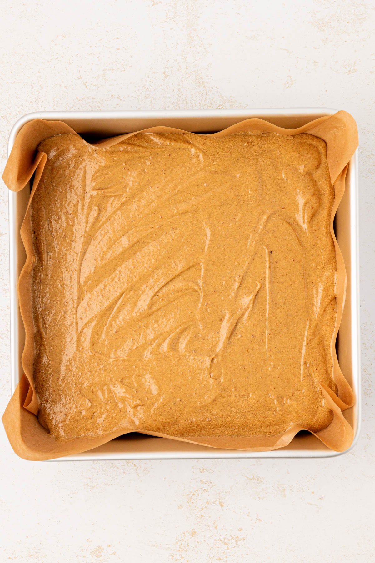 Overhead photo sticky toffee pudding batter in a baking pan.