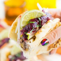 Pulled Pork Tacos with Blueberry Barbecue Sauce are perfect for game days and weeknights! A pork shoulder is slow cooked in root beer, topped with an apple slaw and homemade blueberry barbecue sauce all nestled in delicious naan bread!