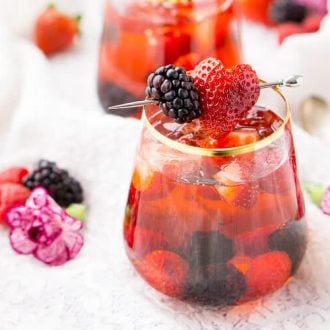 Glass of Rose Sangria garnished with blackberry and strawberry