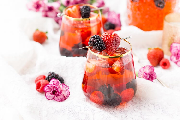 Rosé Berry Sangria is the perfect batch cocktail for Valentine's Day, Bridal Showers, and more! Made with rosé wine, Chambord, blackberry brandy, lemon-lime soda, and fresh berries!