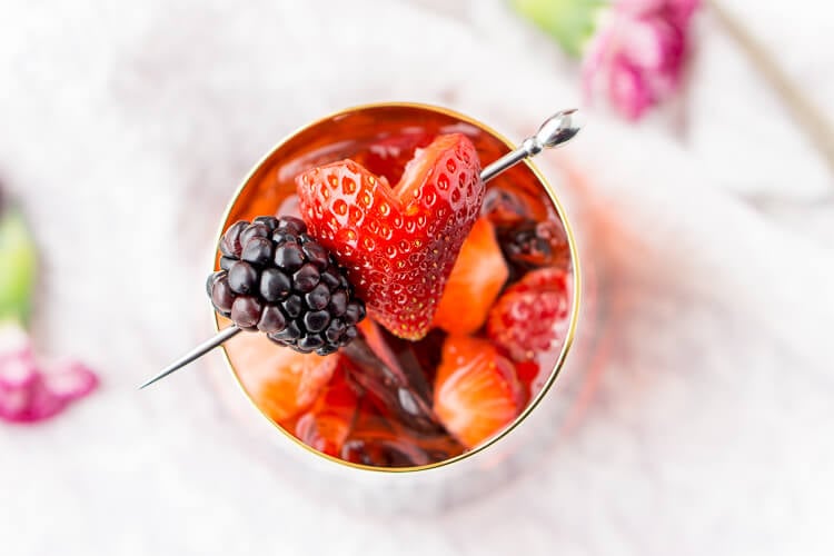 Rosé Berry Sangria is the perfect batch cocktail for Valentine's Day, Bridal Showers, and more! Made with rosé wine, Chambord, blackberry brandy, lemon-lime soda, and fresh berries!