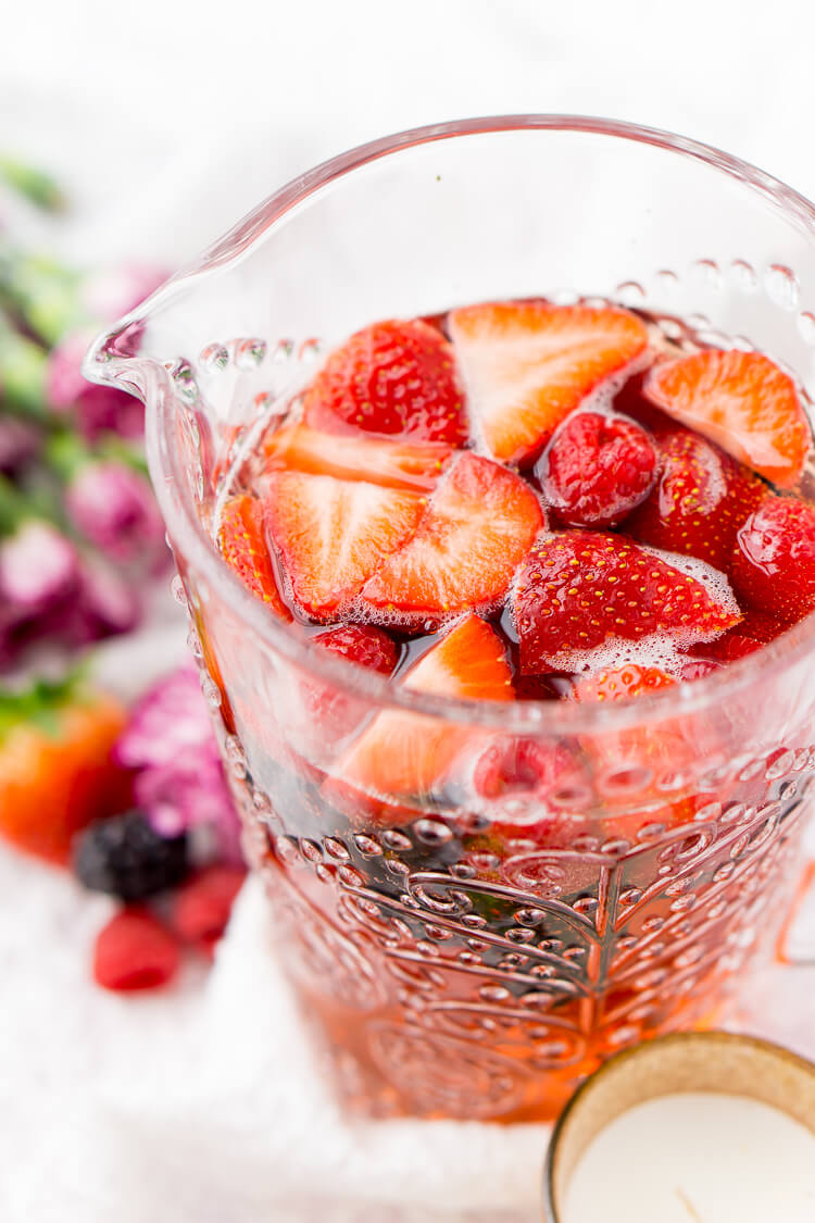 Rosé Berry Sangria is the perfect batch cocktail for Valentine's Day, Bridal Showers, and more! Made with rosé wine, Chambord, blackberry brandy, lemon-lime soda, and fresh berries!