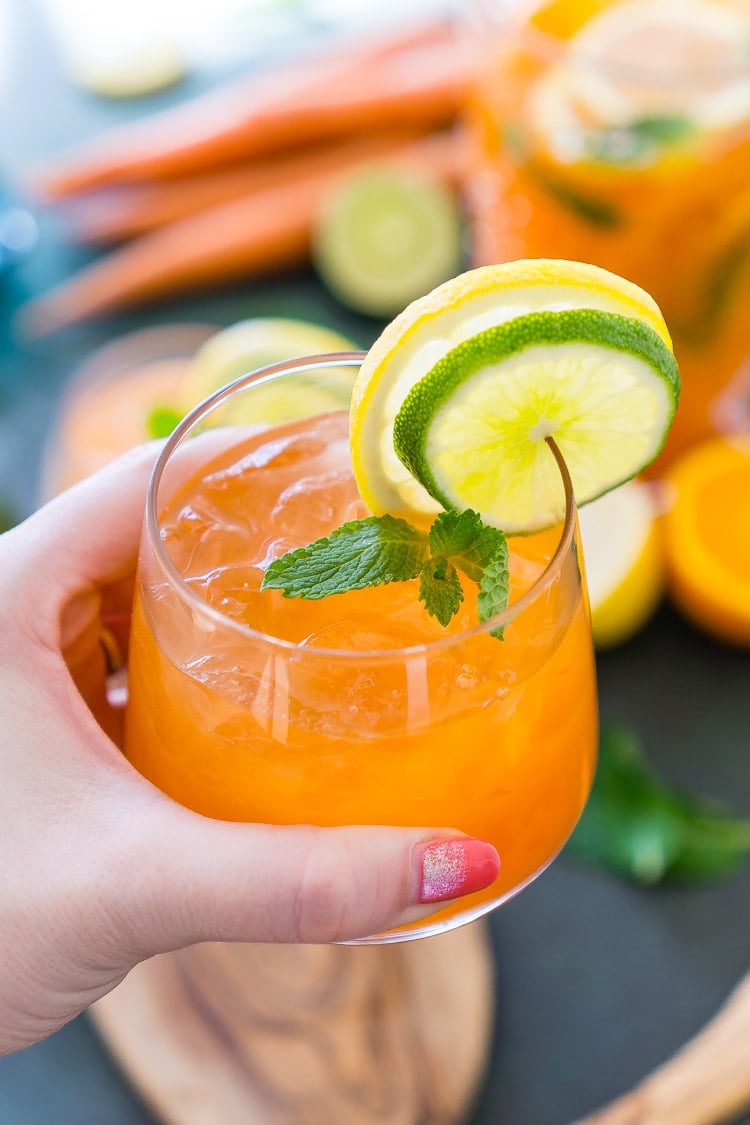 This Carrot Orange Punch is the perfect drink for spring, an easy mix of juice, soda, and fruit slices. It only takes 5 minutes to make and you can add alcohol if you want for a boozy punch!