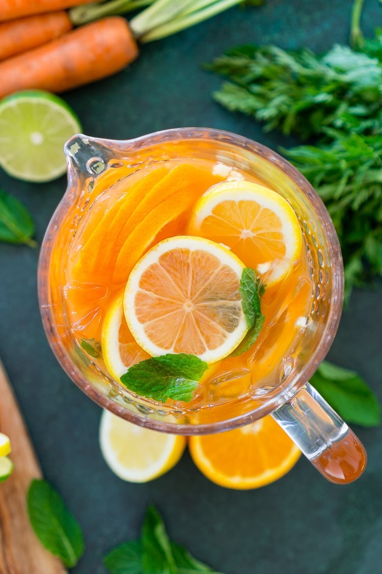 This Carrot Orange Punch is the perfect drink for spring, an easy mix of juice, soda, and fruit slices. It only takes 5 minutes to make and you can add alcohol if you want for a boozy punch!