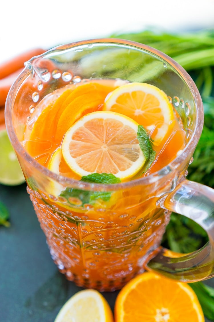This Carrot Orange Punch is the perfect drink for spring, an easy mix of juice, soda, and fruit slices. It only takes 5 minutes to make and you can add alcohol if you want for a boozy punch!