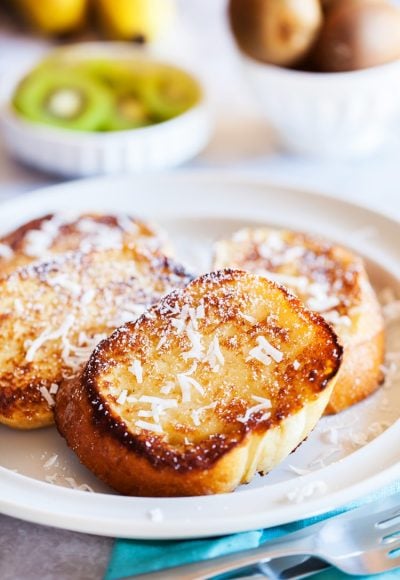 This Coconut French Toast is an easy breakfast that's served with an addictively delicious and creamy coconut syrup made with butter, buttermilk, sugar, and coconut extract!