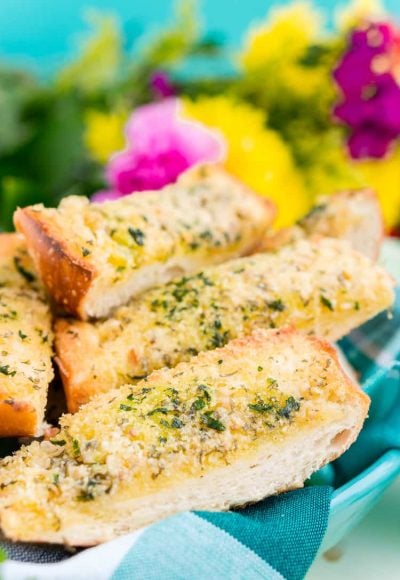 This Parmesan Garlic Bread is the perfect side for Bertolli's Frozen Chicken Florentine. A quick and easy recipe loaded with herbs, butter, and Parmesan cheese that can be whipped up in minutes!