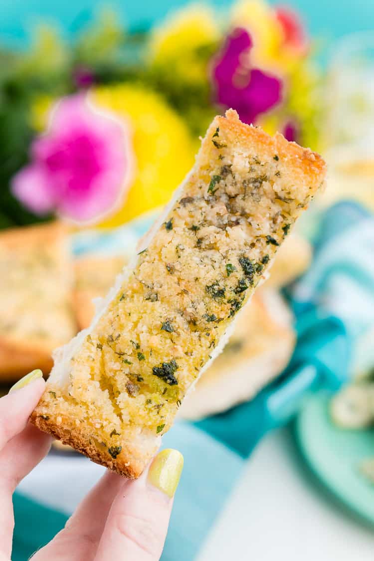 This Parmesan Garlic Bread is the perfect side for Bertolli's Frozen Chicken Florentine. A quick and easy recipe loaded with herbs, butter, and Parmesan cheese that can be whipped up in minutes!