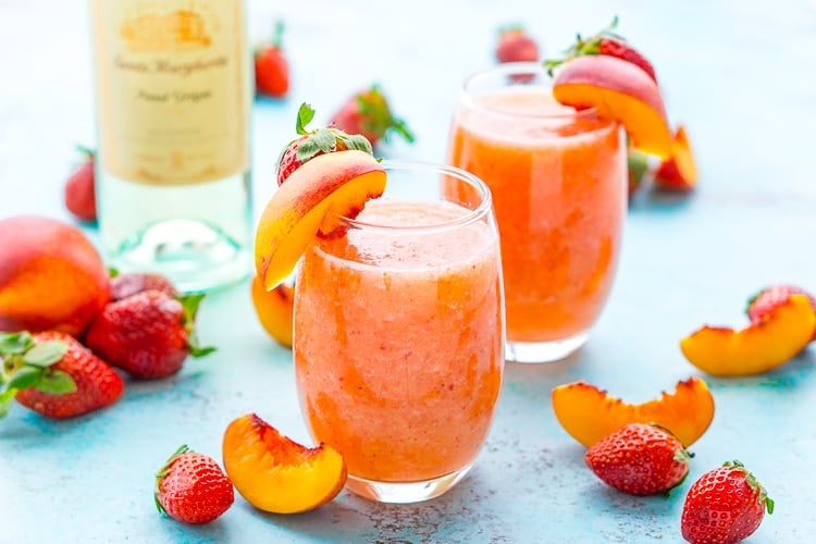 Strawberry Peach Wine Slushies are made with just a few ingredients and a blender. Mix them up for a night with the girls or a summer day by the pool!