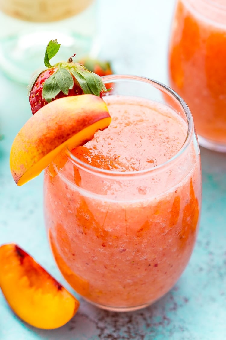 Strawberry Peach Wine Slushies are made with just a few ingredients and a blender. Mix them up for a night with the girls or a summer day by the pool!