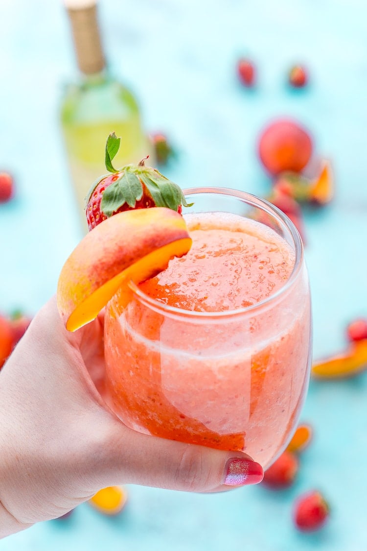 Strawberry Peach Wine Slushies are made with just a few ingredients and a blender. Mix them up for a night with the girls or a summer day by the pool!