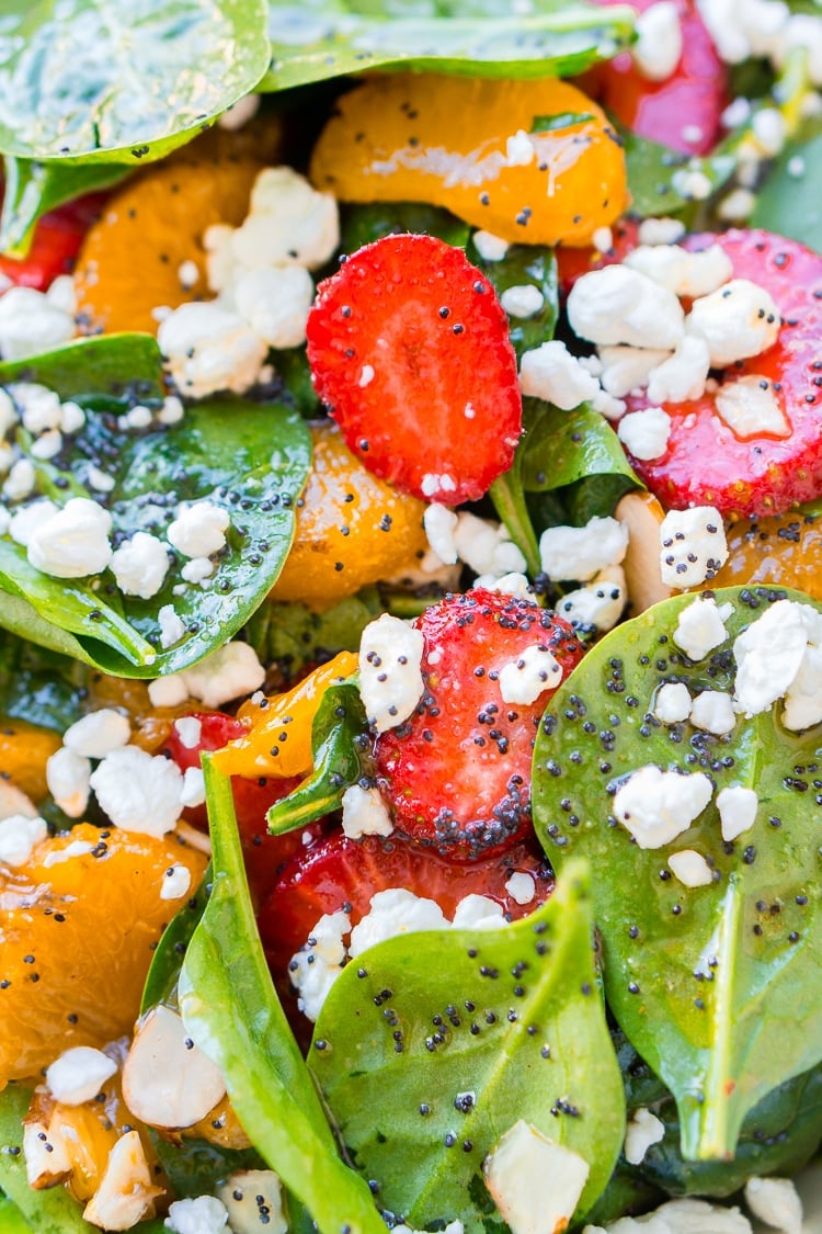 This Strawberry Spinach Salad will become your new go-to recipe for summer, it's made with simple, flavorful ingredients like goat cheese, almonds, poppyseeds, strawberries, mandarins, and spinach, and you can make it family or party-sized!