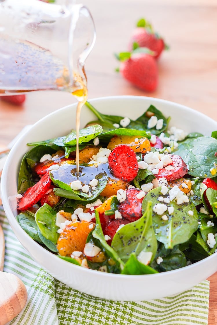 This Strawberry Spinach Salad will become your new go-to recipe for summer, it's made with simple, flavorful ingredients like goat cheese, almonds, poppyseeds, strawberries, mandarins, and spinach, and you can make it family or party-sized!