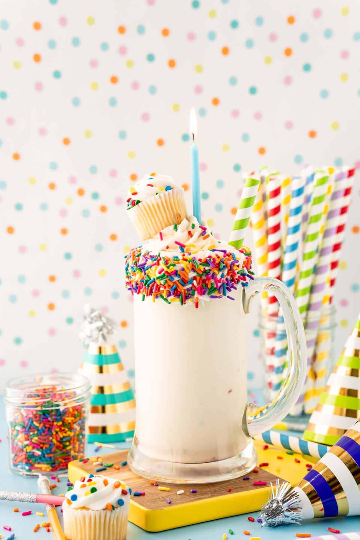 Close up of a birthday cake milkshake in a tall glass mug.