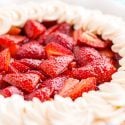 Close up photo of strawberry pie made with jello and topped with whipped cream.