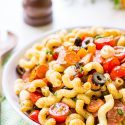 Antipasti Pasta Salad recipe is loaded with veggies, cheeses, herbs, and meats and coated in a simple balsamic and olive oil dressing.