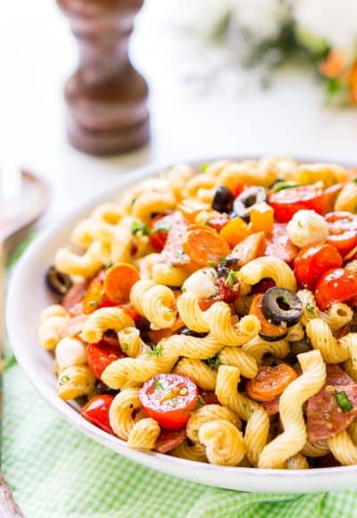 Antipasti Pasta Salad recipe is loaded with veggies, cheeses, herbs, and meats and coated in a simple balsamic and olive oil dressing.
