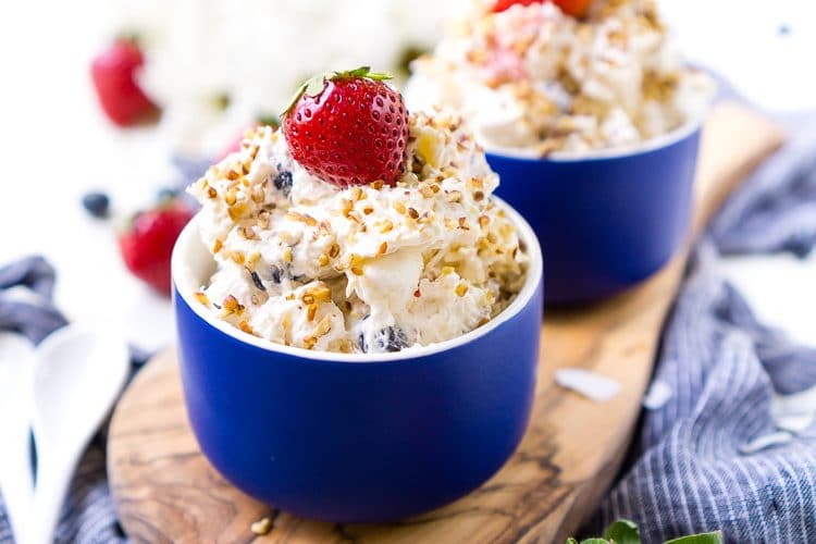 This Red White & Blue Ambrosia Salad is a delicious, no-bake, retro dessert recipe that's easy, addictive, and loaded with strawberries, blueberries, coconut, and pineapple!