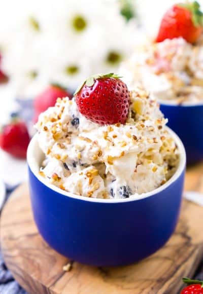 This Red White & Blue Ambrosia Salad is a delicious, no-bake, retro dessert recipe that's easy, addictive, and loaded with strawberries, blueberries, coconut, and pineapple!