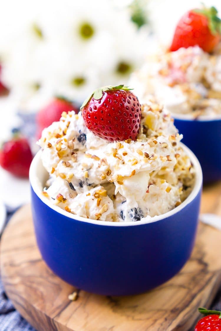 This Red White & Blue Ambrosia Salad is a delicious, no-bake, retro dessert recipe that's easy, addictive, and loaded with strawberries, blueberries, coconut, and pineapple!