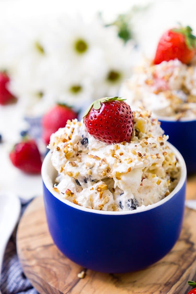 This Red White & Blue Ambrosia Salad is a delicious, no-bake, retro dessert recipe that's easy, addictive, and loaded with strawberries, blueberries, coconut, and pineapple!