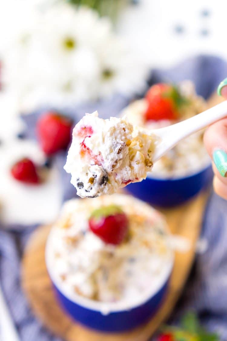 This Red White & Blue Ambrosia Salad is a delicious, no-bake, retro dessert recipe that's easy, addictive, and loaded with strawberries, blueberries, coconut, and pineapple!