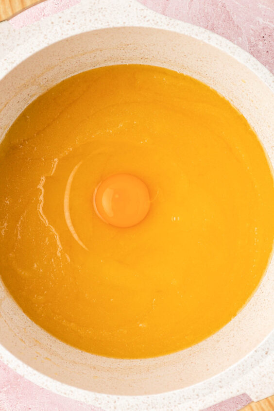 Egg being added to a butter and sugar base.